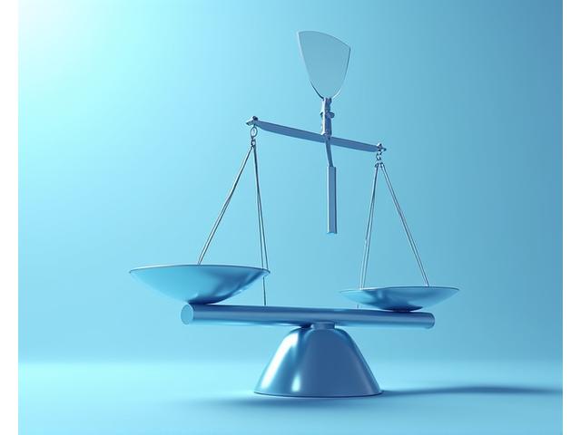 Symbolic image of balanced legal scales with a protective shield, representing personal liability coverage.